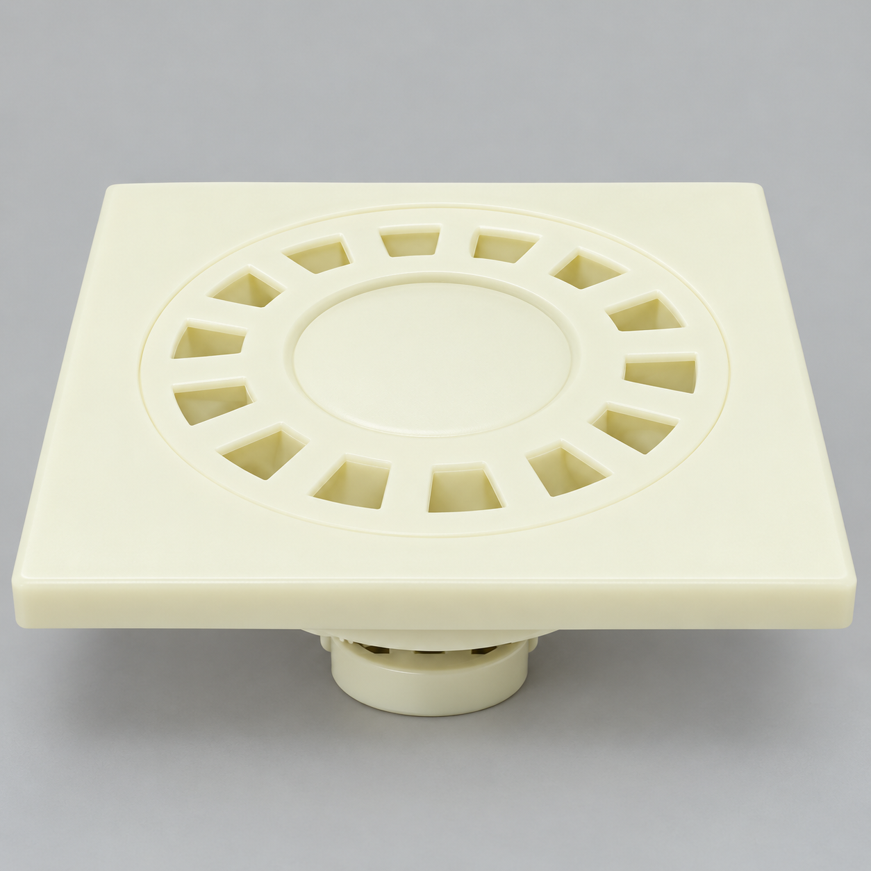 Cream square floor drain with radial rectangular slots and bottom outlet